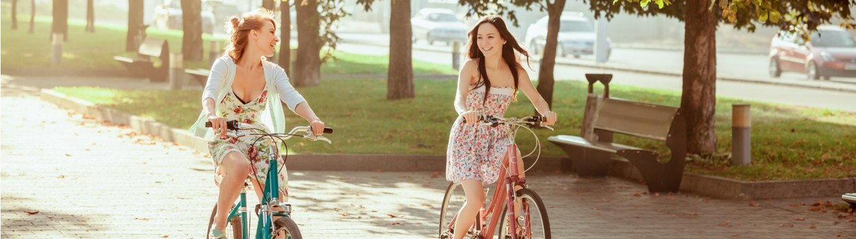 Two women riding bikes